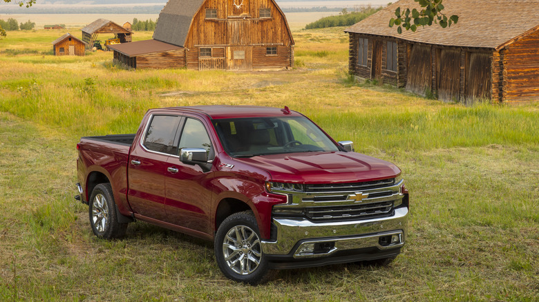 red 2021 Chevy Silverado 1500 LTZ in front of barn