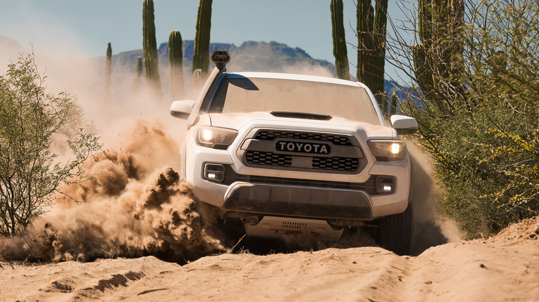 White 2019 Toyota Tacoma bajaing through the desert