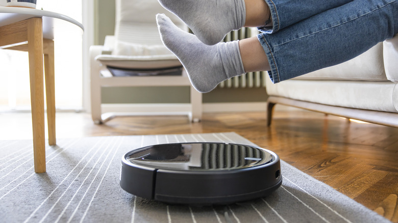 Legs hovering over a robot vacuum