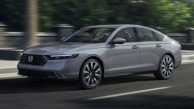 Side view of silver Honda Accord driving on the street