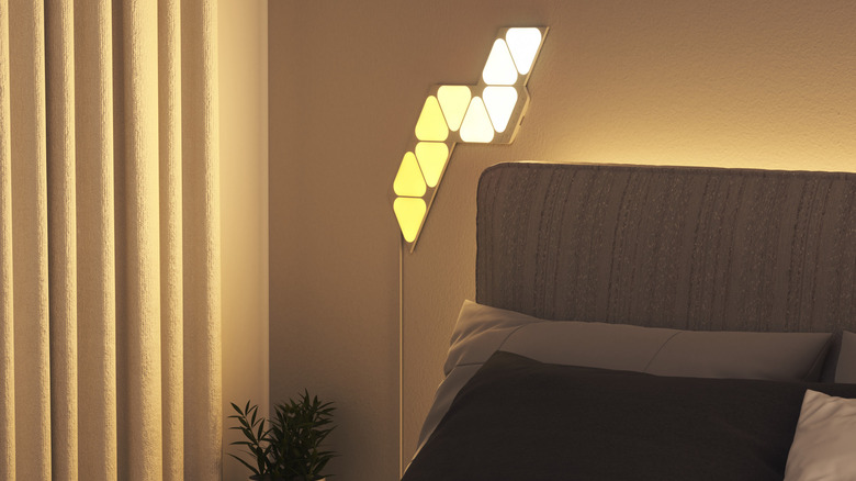 Nanoleaf Shapes lights on wall above bed