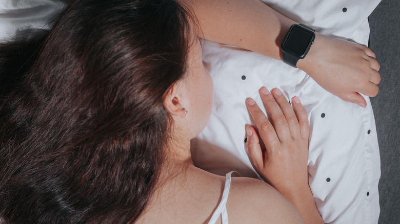 person sleeping wearing smartwatch