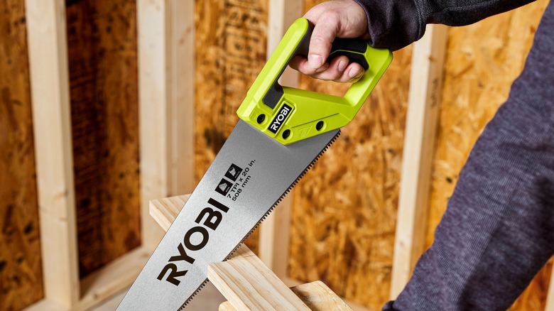 person using ryobi hand saw