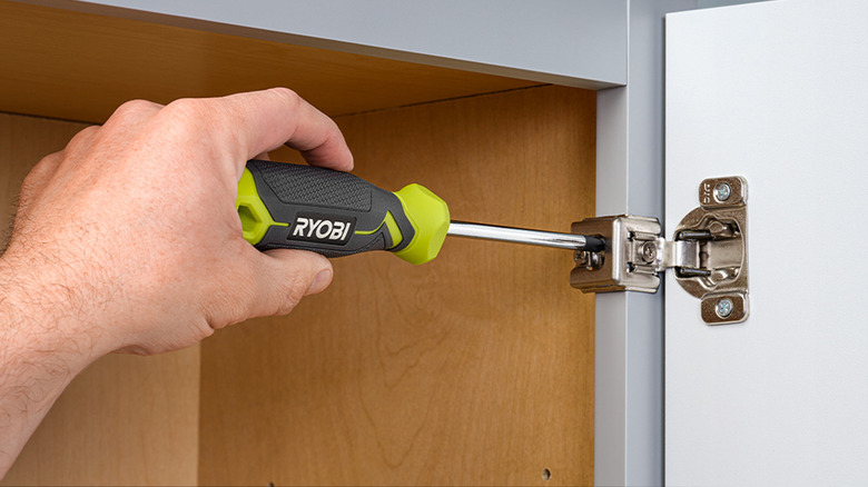 person using ryobi screwdriver