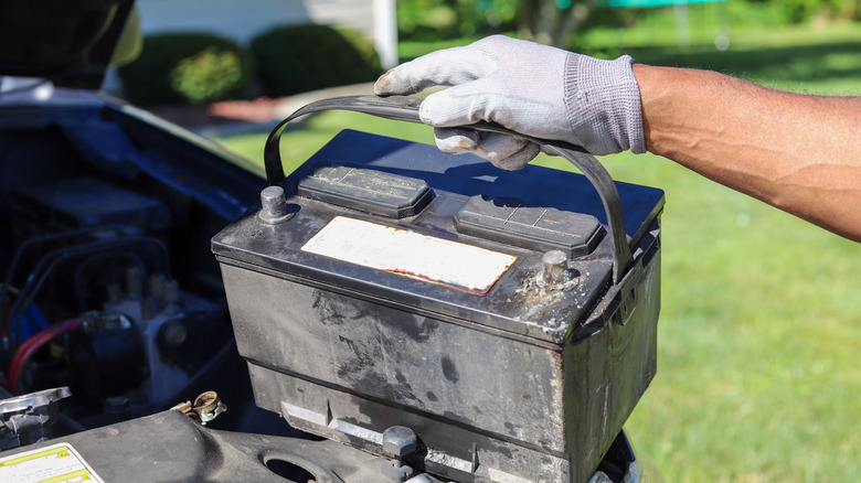 Man removing old battery