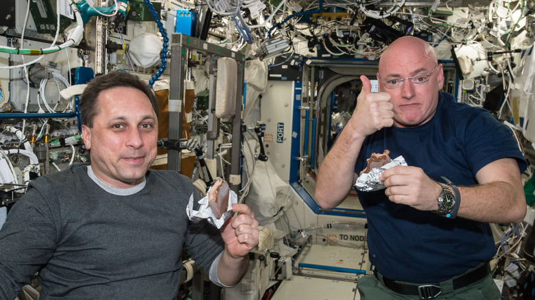 Astronauts eat aboard the International Space Station