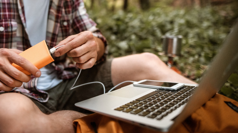 Power bank, laptop, smartphone in nature