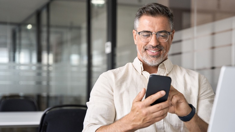 Man smiling at his phone