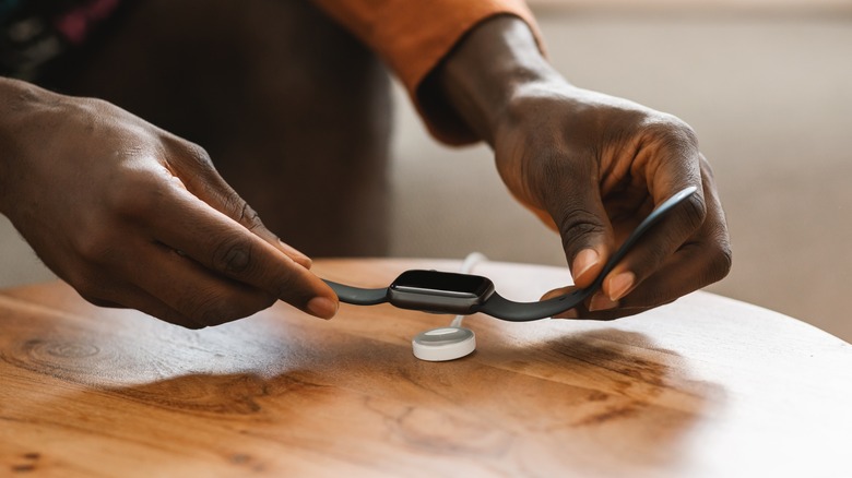 person charging Apple Watch