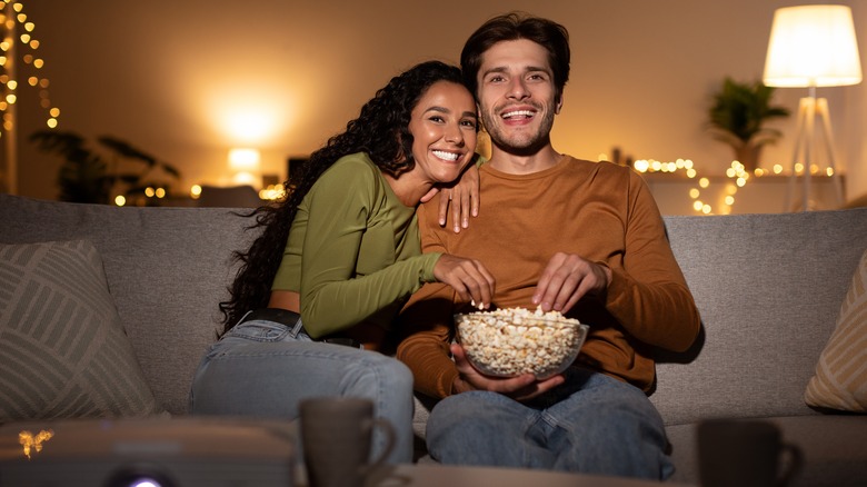 Couple watching movie on couch