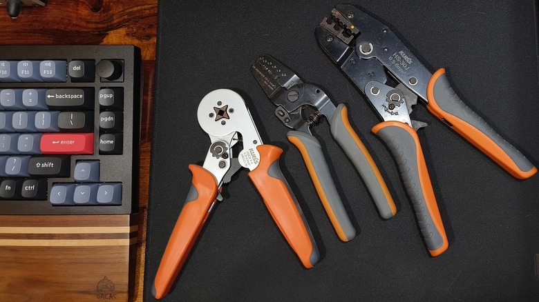 Various crimping tools alongside a keyboard