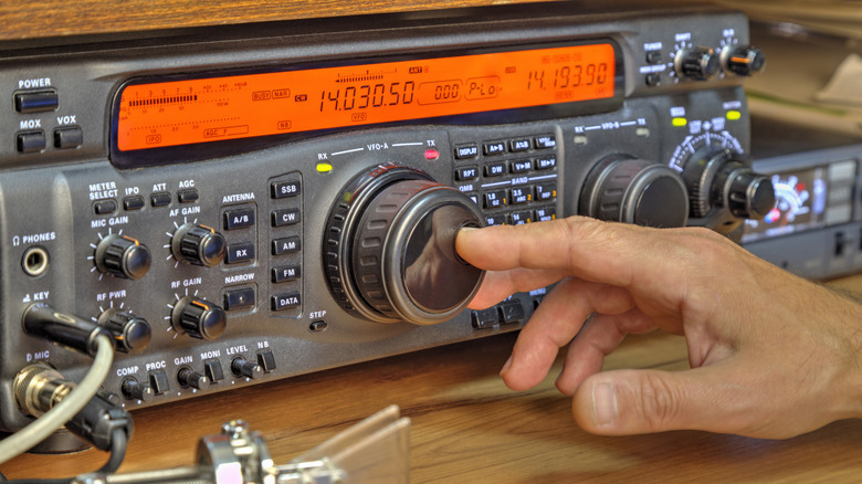 Hand moving knob on radio