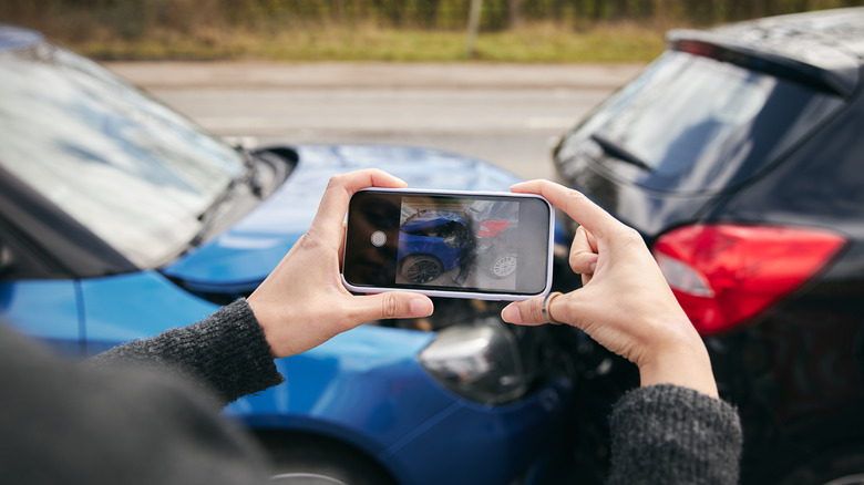 person taking photos of an accident