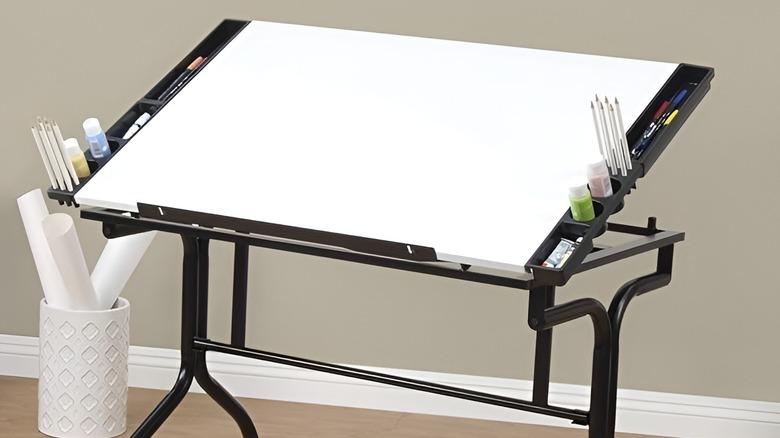 Blank craft table with art supplies in an empty room