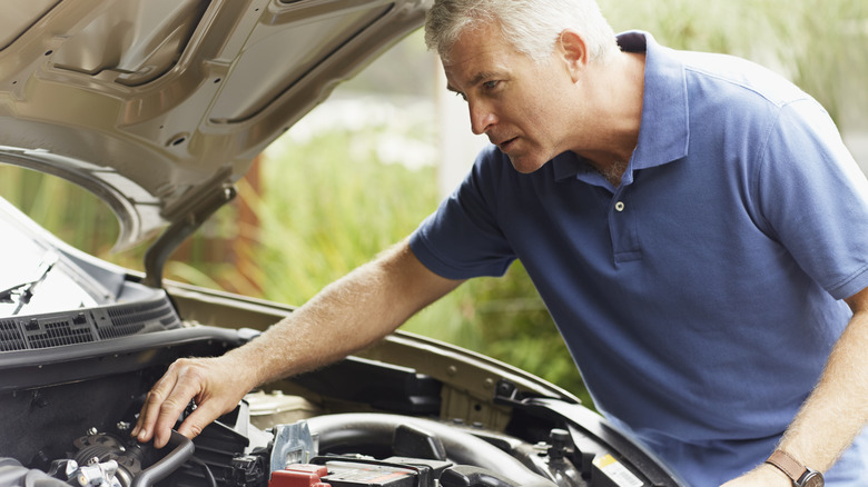 Man inspecting car