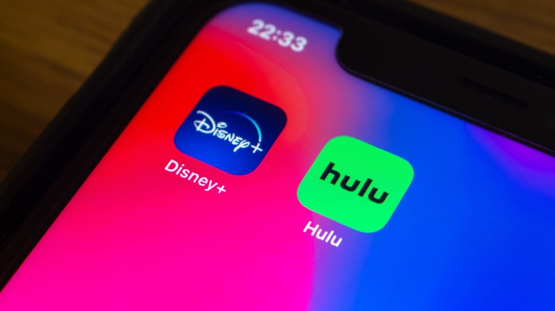 phone with Disney+ and Hulu app icons