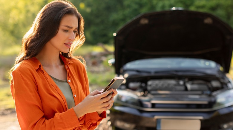 Woman standing in front of a car