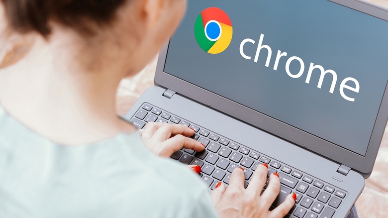 Person typing on laptop with Chrome logo