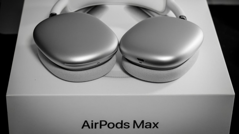 Silver AirPods Max on top of their box