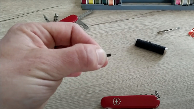 putting needle inside tweezers