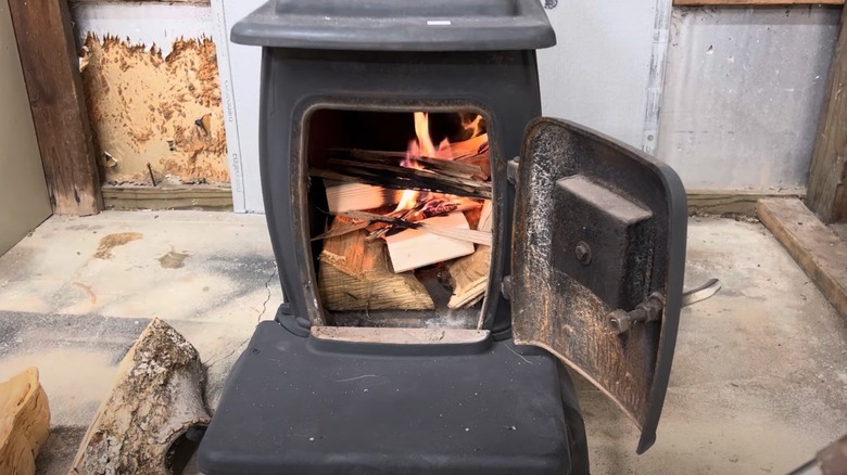 Wood burning fireplace set up inside a garage