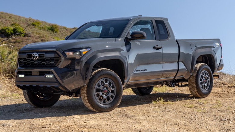 Toyota Tacoma PreRunner parked off-road next to a hillside