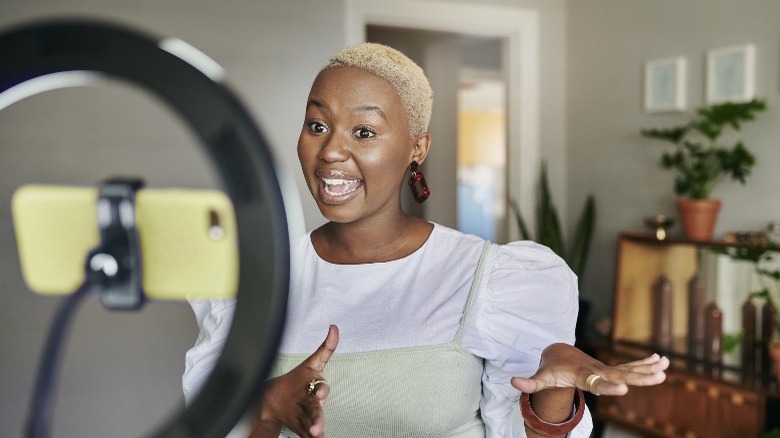 Woman recording herself with light ring