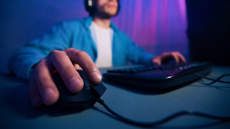 Person using a computer mouse and keyboard