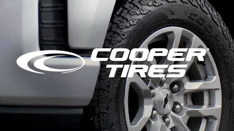 Logo for Cooper Tires backed by tire on car