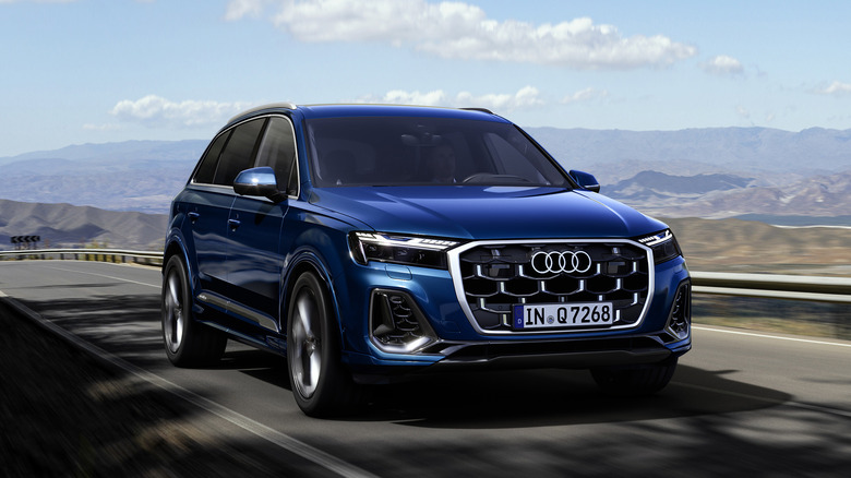 Blue Audi Q7 driving mountain road