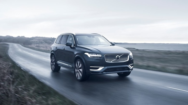 Volvo XC90 driving down rainy road