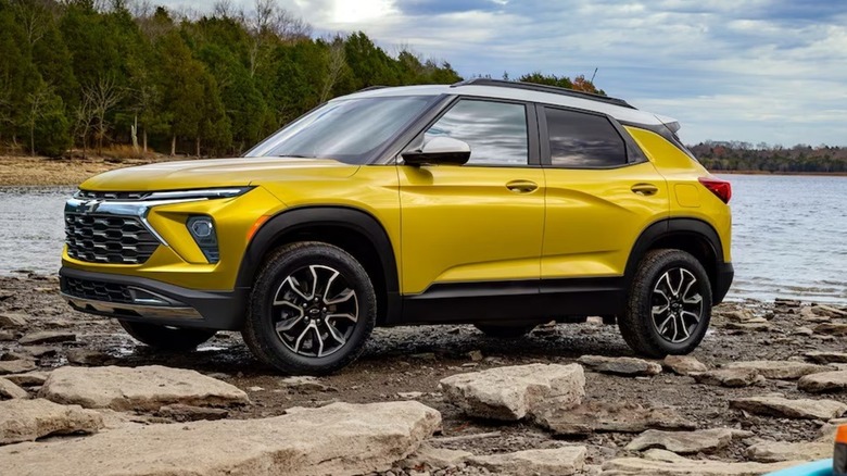 A Chevy Trailblazer parked on a rocky shoreline