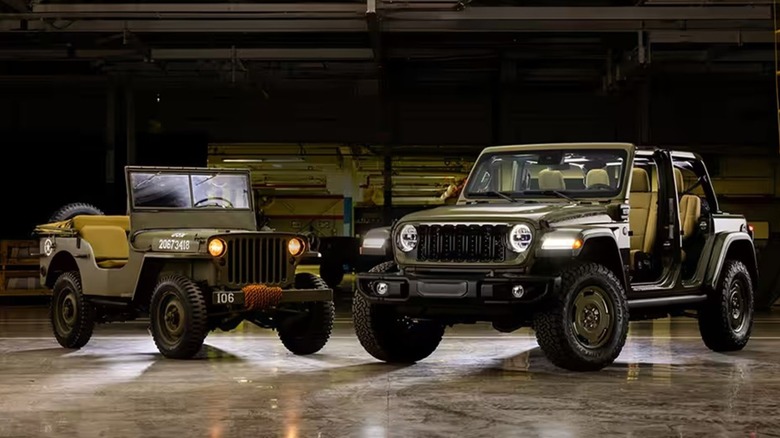 A 2025 Jeep Wrangler parked next to WWII Willys MB.