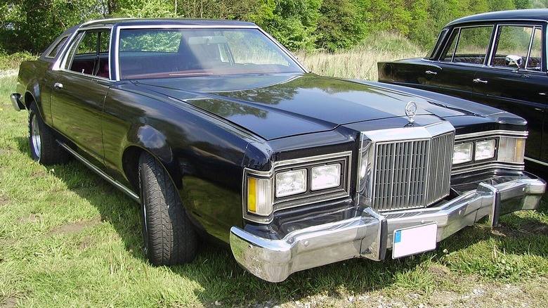 Black 1977 Mercury cougar parked in grass