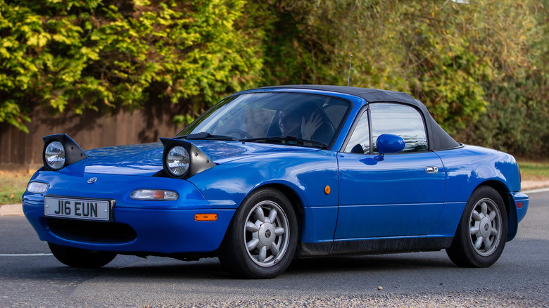 Blue Miata being driven