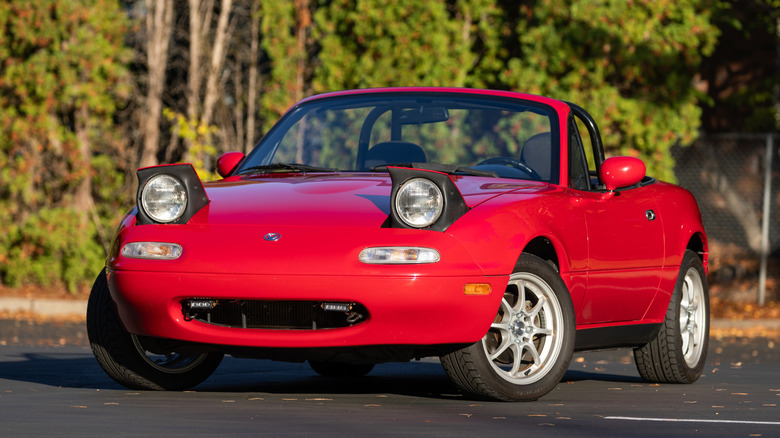 Red Miata with headlights up