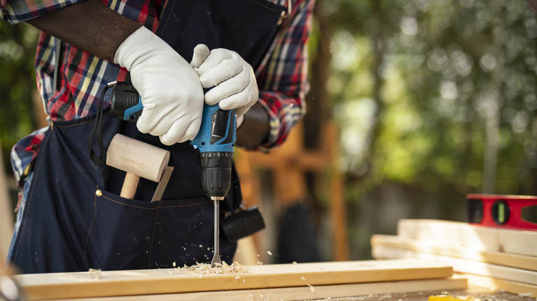 Hand Is Covering Air Vents Of The Power Drill