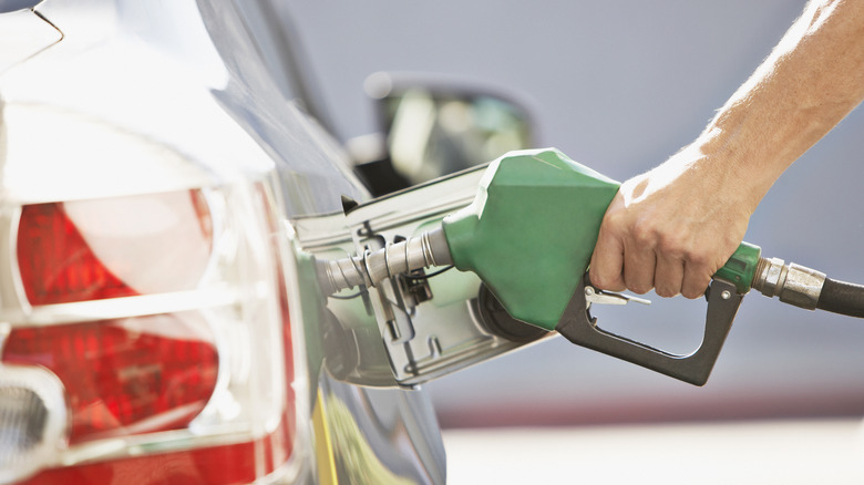 Hand refueling a car