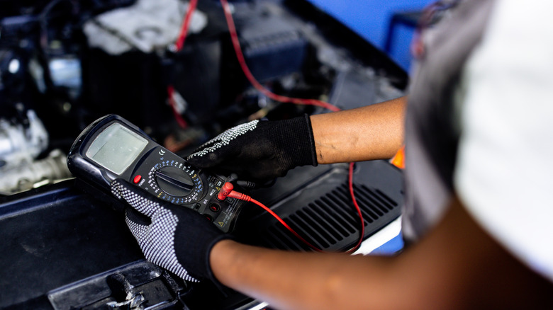 person testing car battery