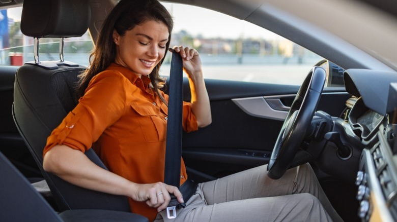 Woman wearing a seat belt in a car