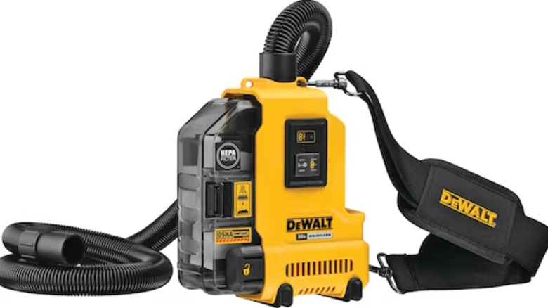 A DeWalt cordless dust extractor with the hose unraveled.