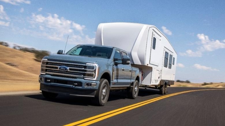 2023 Ford F-350 Super Duty Lariat pulling camper on road