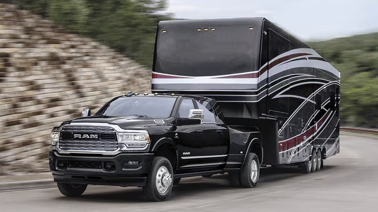 2024 Ram 3500 pulling camper along curve in road