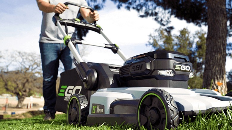 Man cutting grass with EGO mower