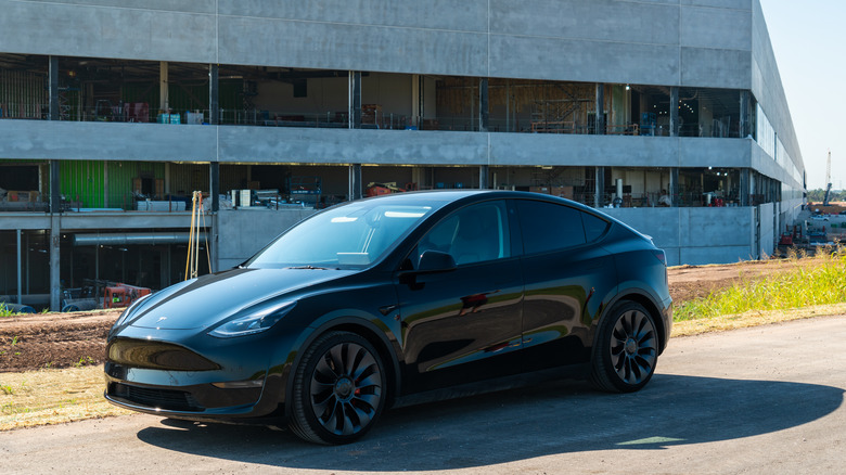 black Tesla Model Y parked in front of building