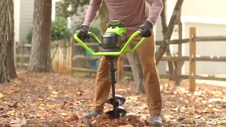 Person using Greenworks Auger