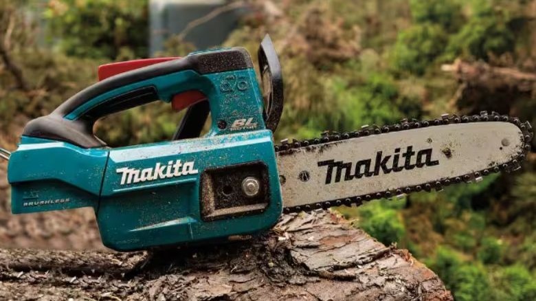 Makita 10-inch top-handle chainsaw on a log.