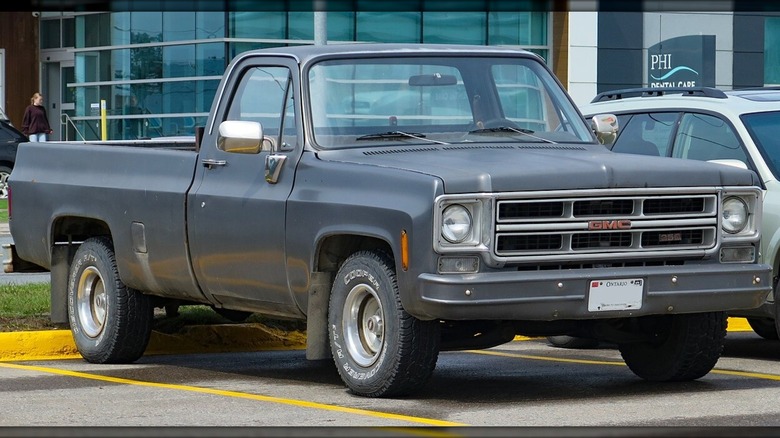 A 1975 GMC square-body truck in a parking lot