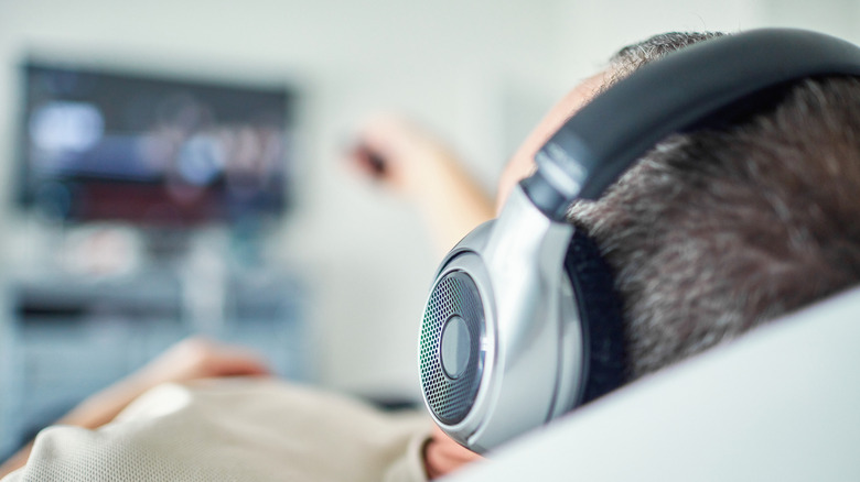 Man watching TV with headphones