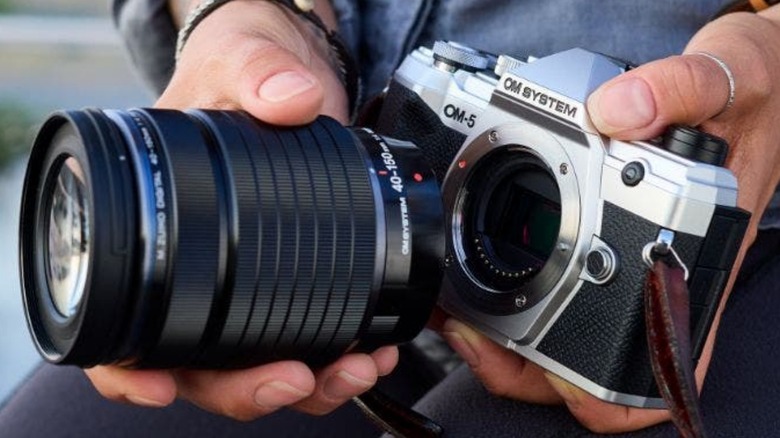 Hands holding camera lens